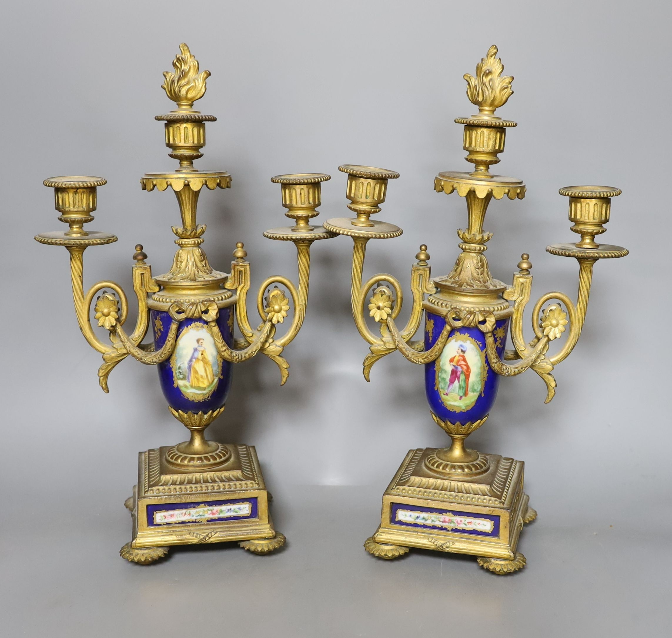 A pair of Sevres style porcelain and ormolu candelabra, 36 cms high.